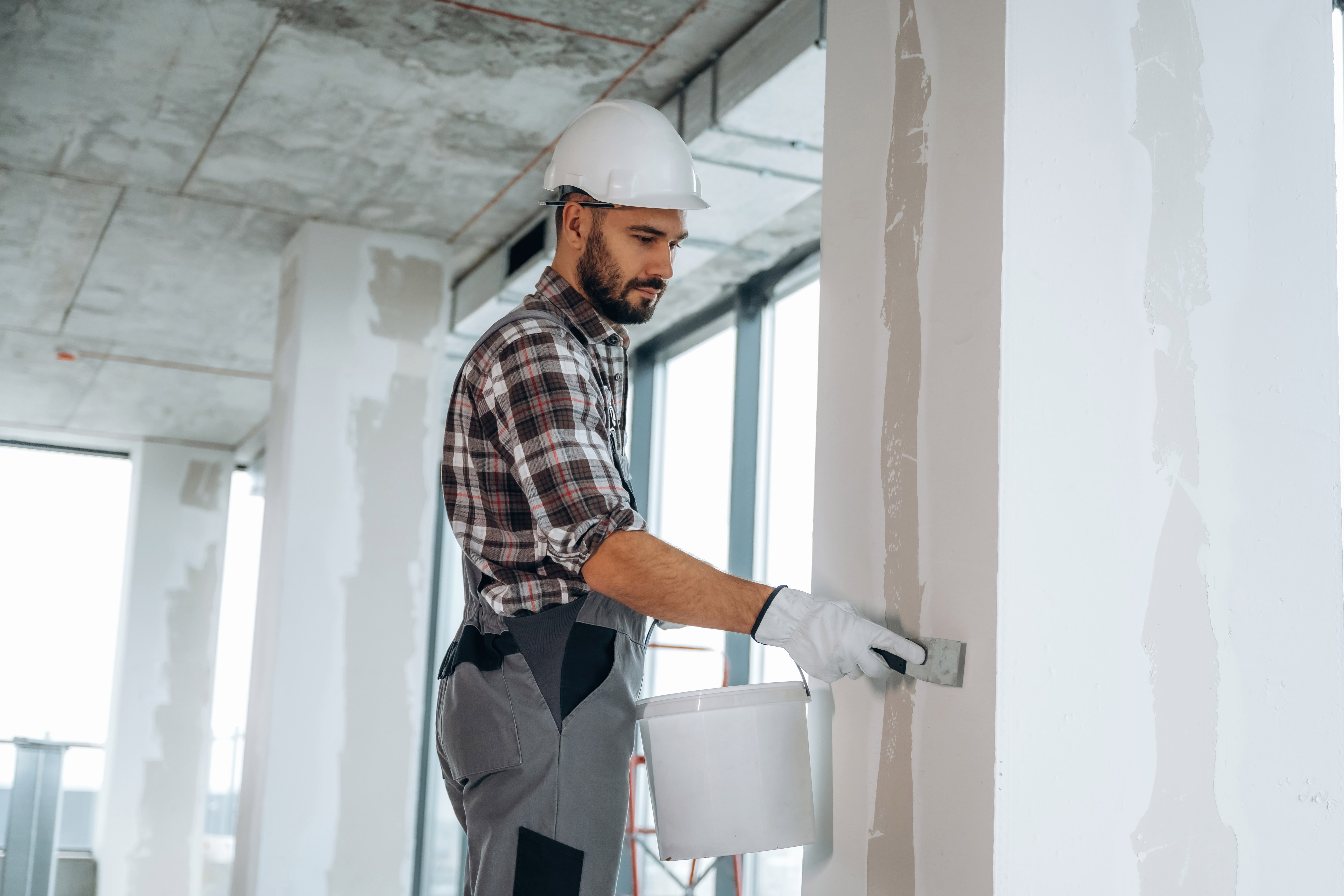 Construction worker applying plaster to a wall